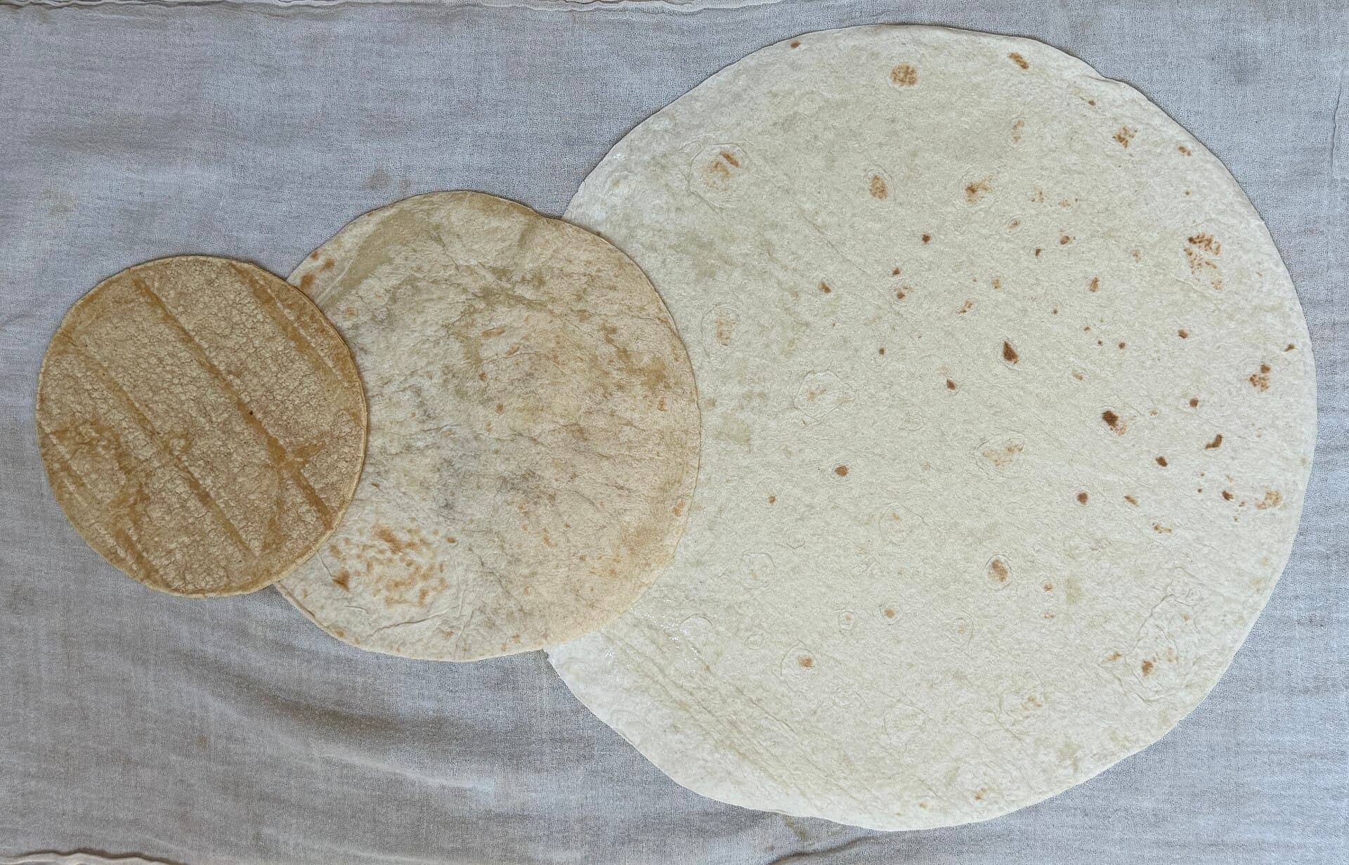 Corn tortilla, medium flour tortilla, and large flour tortilla, spread out