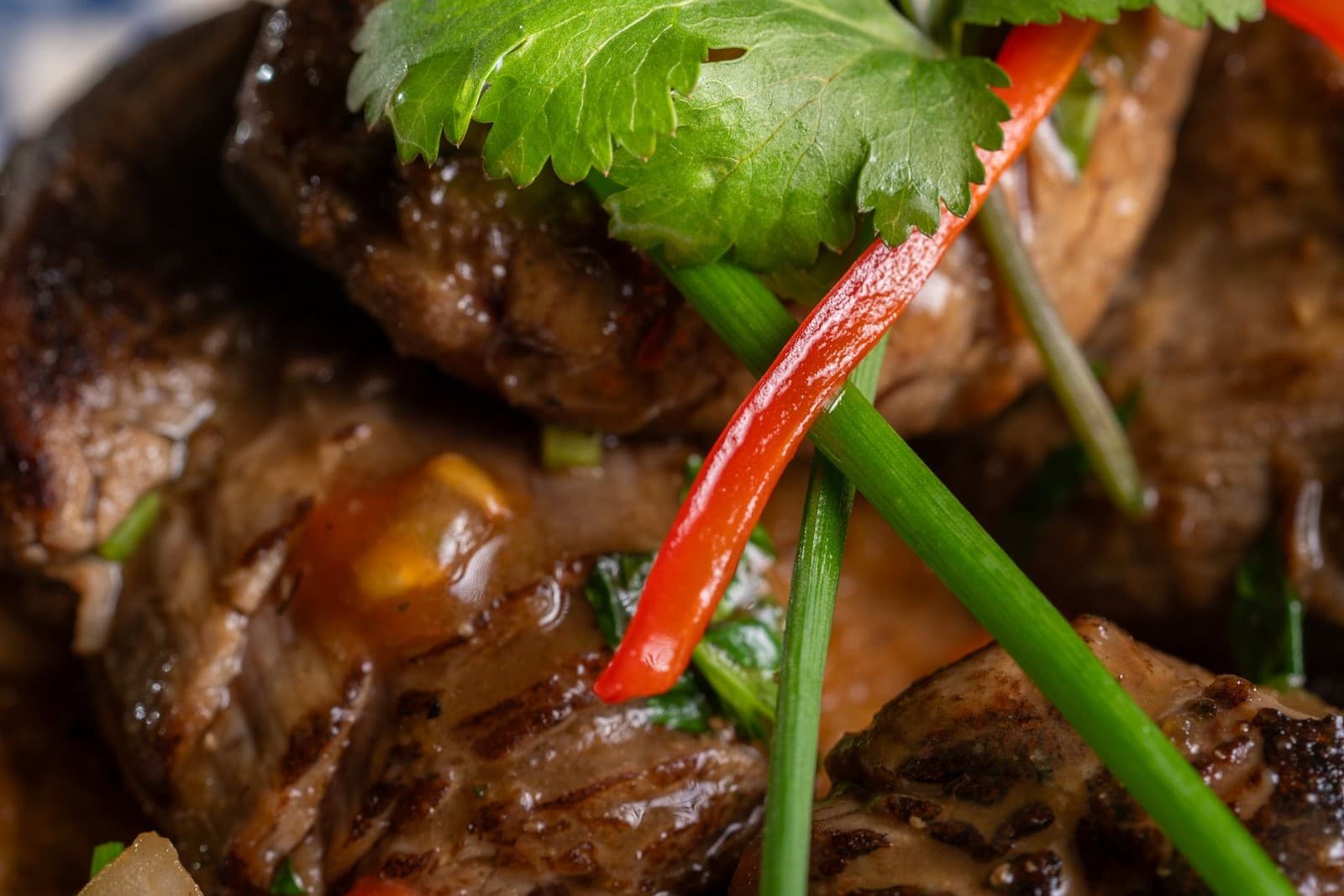 Grilled beef with red chile strips and cilantro