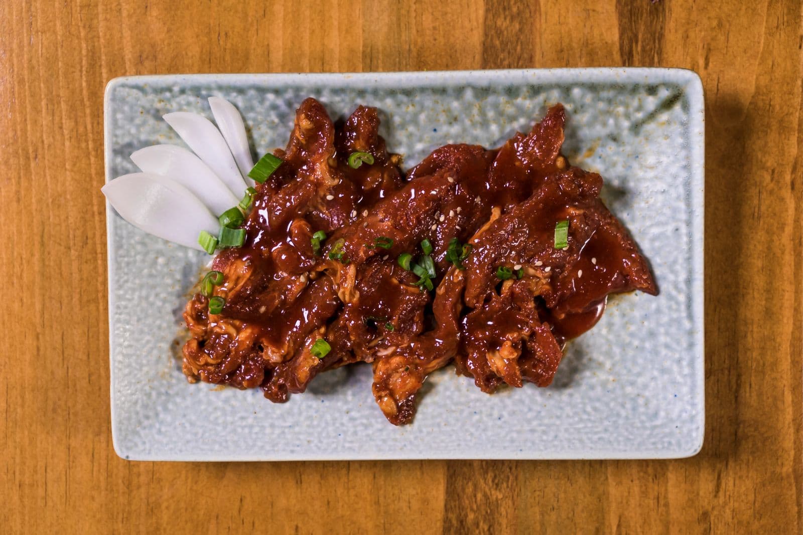 Glossy gochujang-glazed beef with scallions and sesame