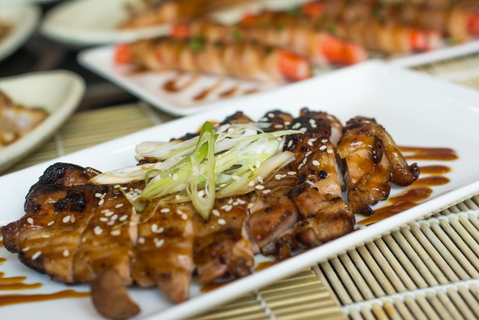 Glazed teriyaki chicken strips with scallions and sesame