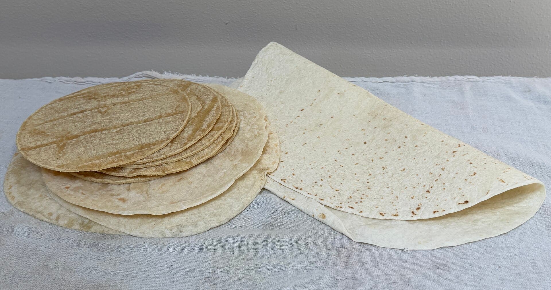 Stack of corn and flour tortillas and a large flour tortilla